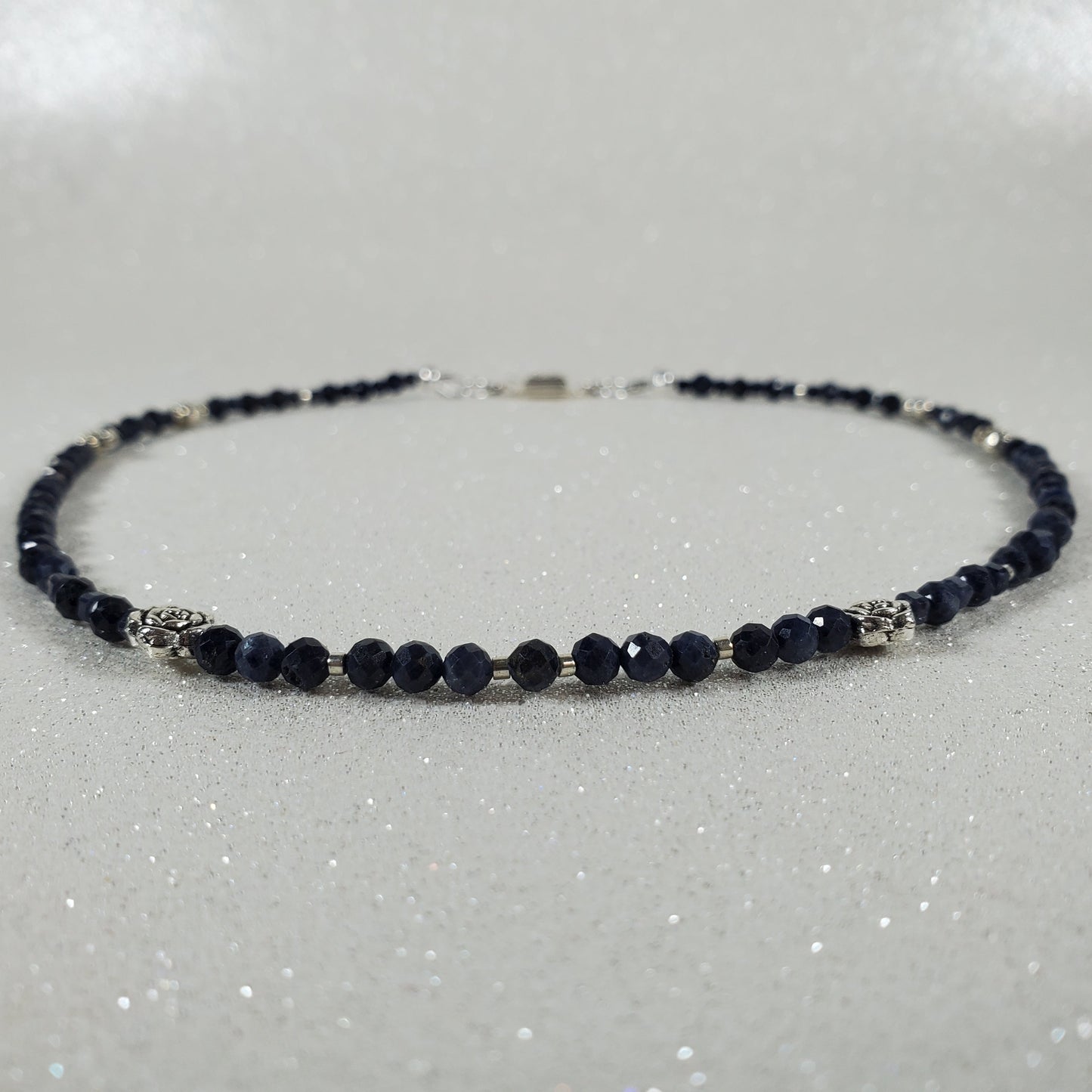 Necklace with dark blue beads on a white background