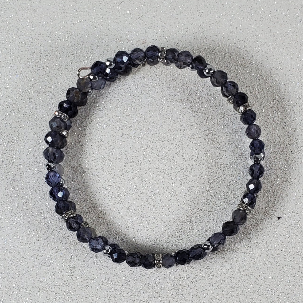Blue beaded bracelet on a light gray background