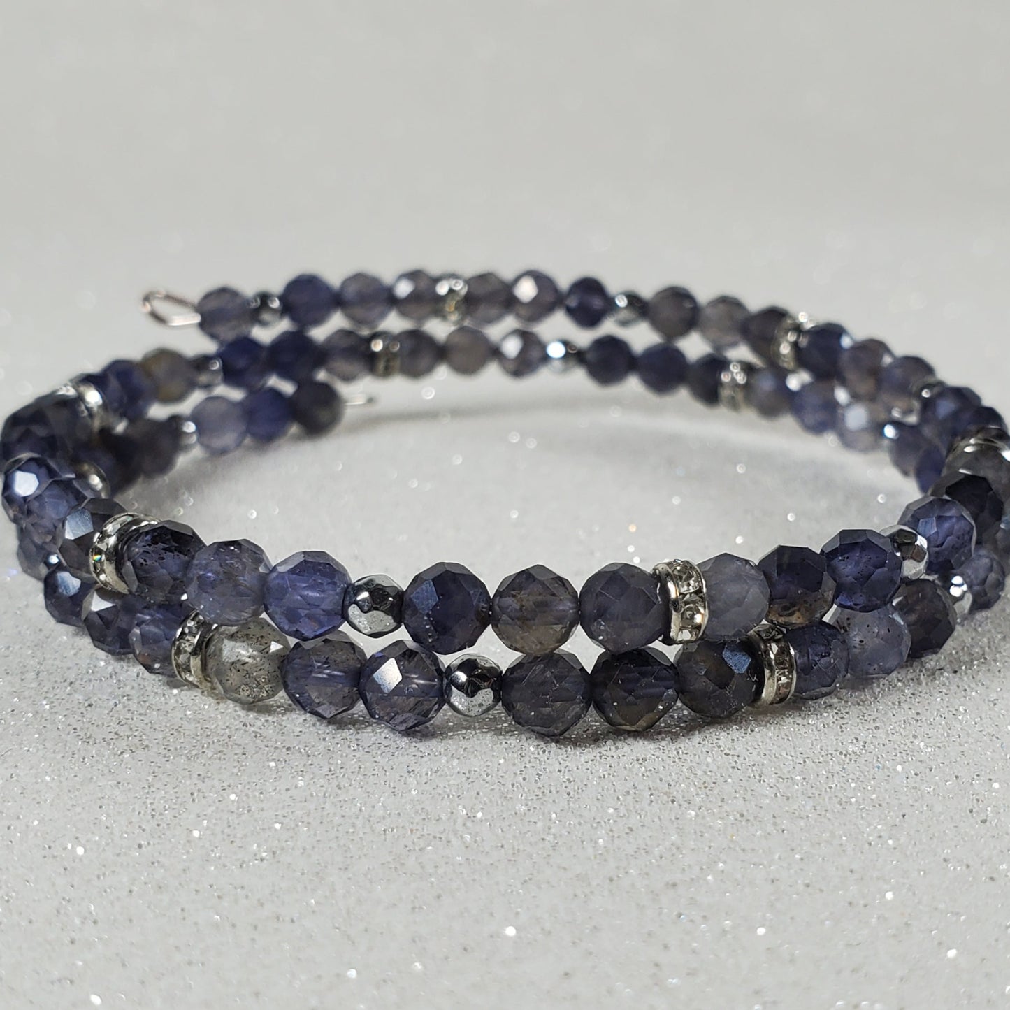 Beaded bracelet with blue and purple stones on a white background