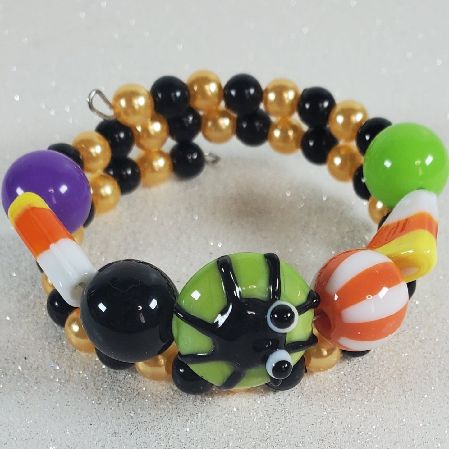 Colorful beaded bracelet with candy corn design on a white background