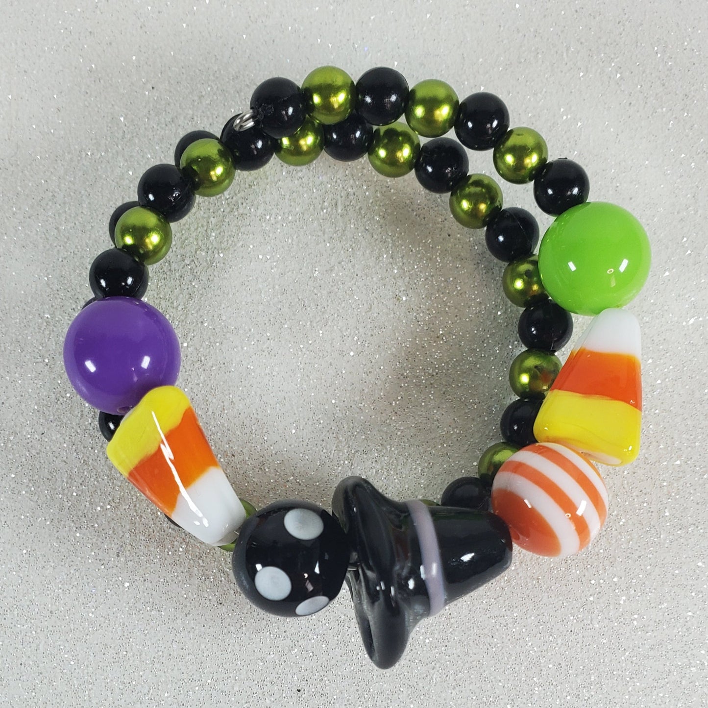 Colorful beaded bracelet with candy-themed beads on a light gray background