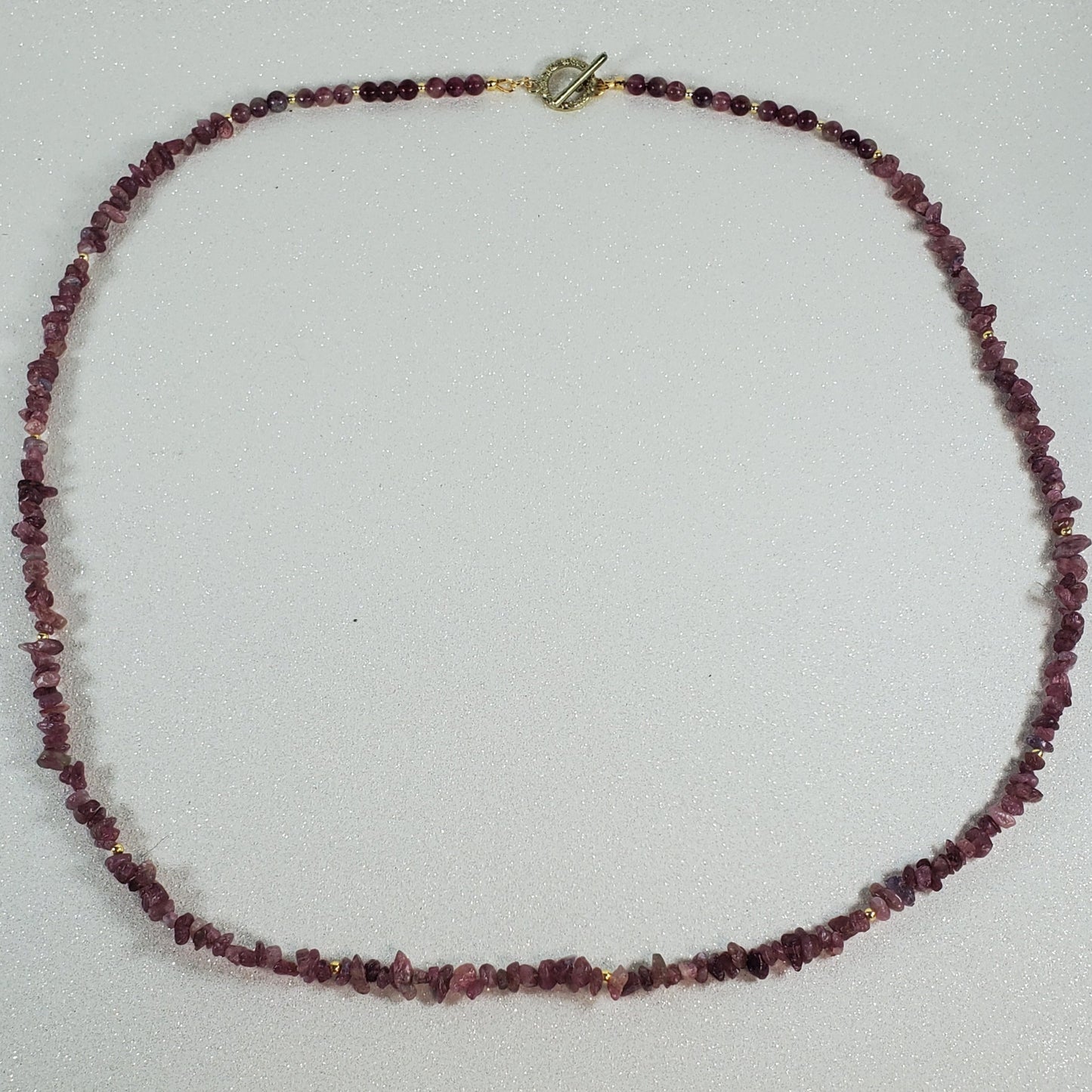 Necklace with red beads on a white surface