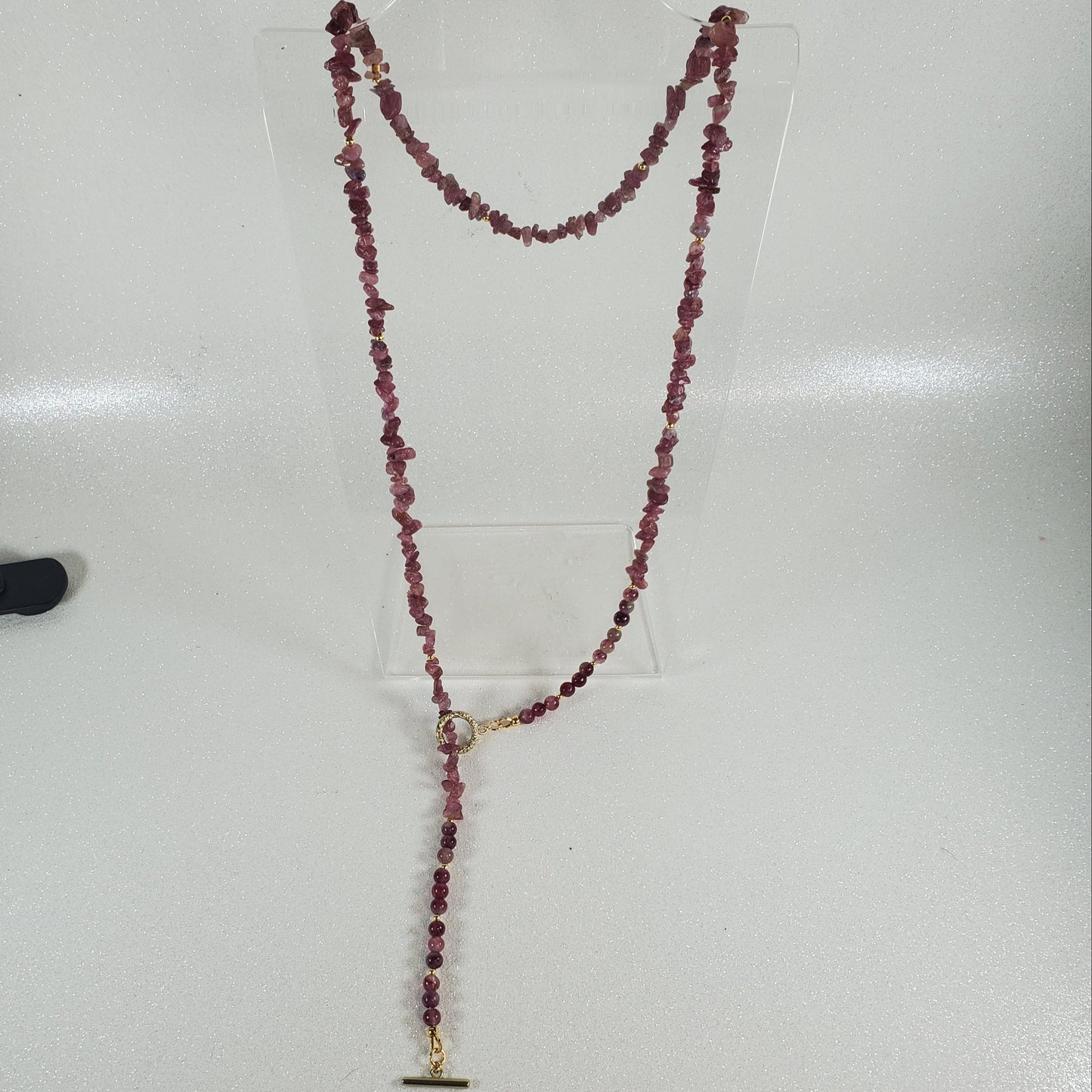 Necklace with red beads on a white surface