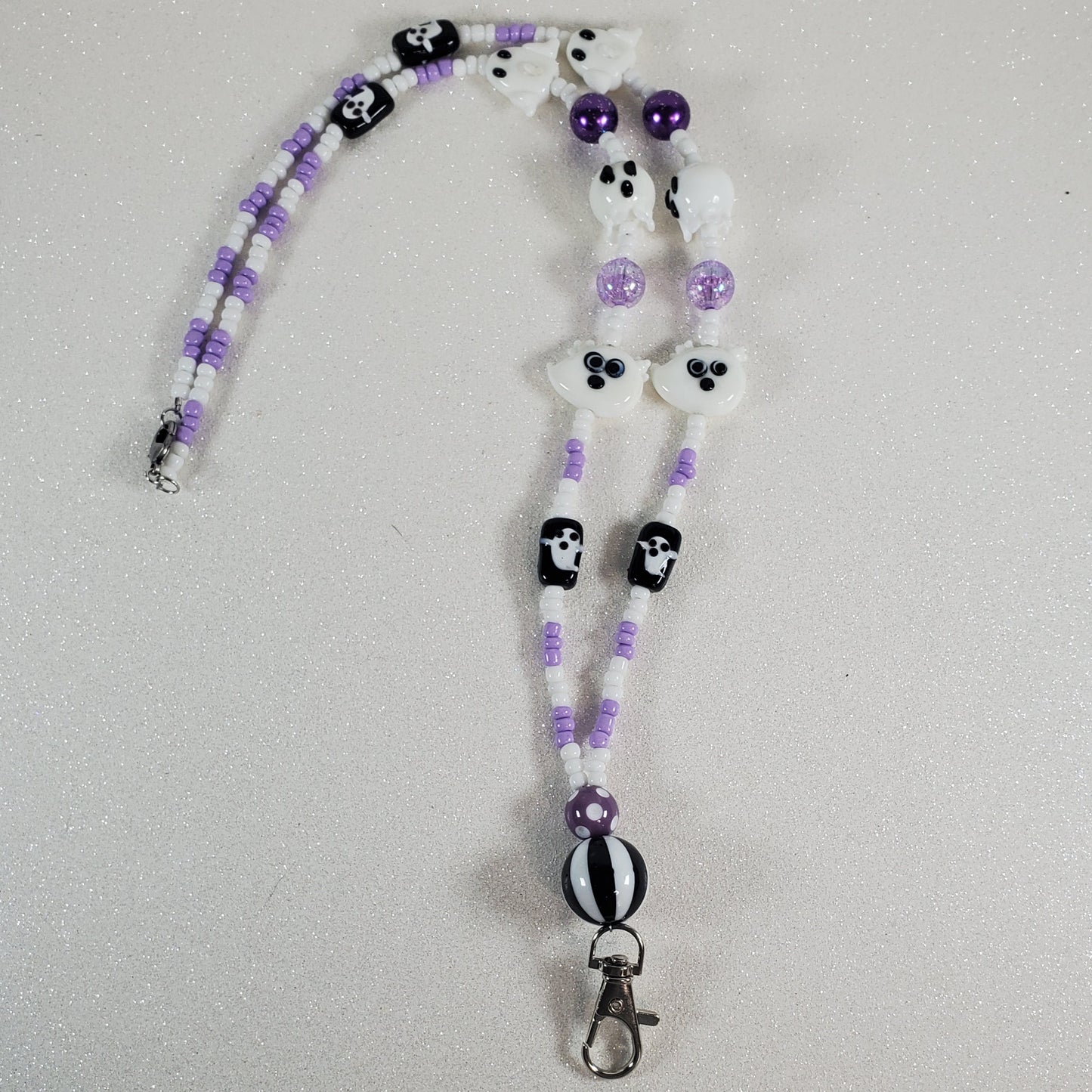 Beaded lanyard with ghost design on a light gray background