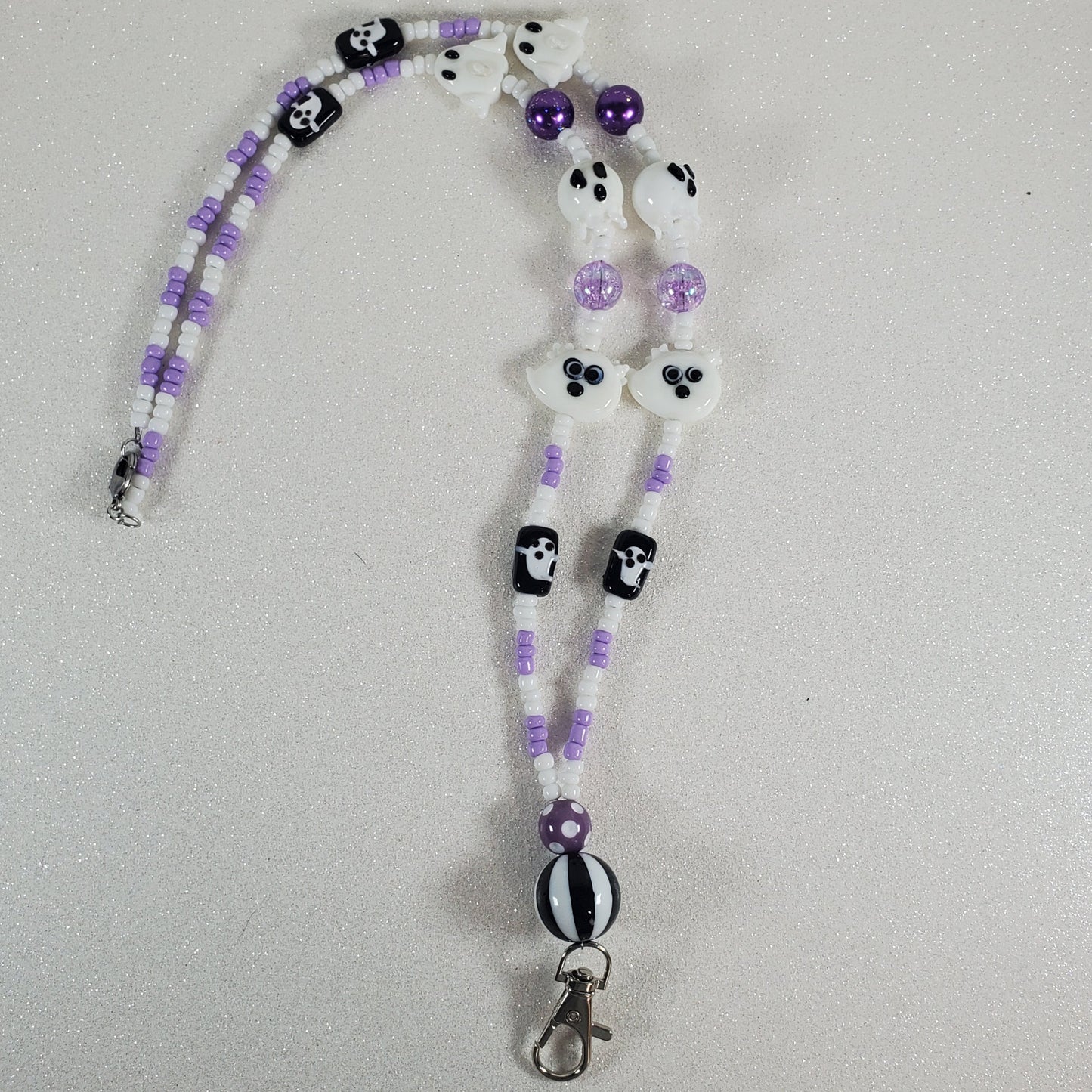Beaded lanyard with ghost designs on a light gray background