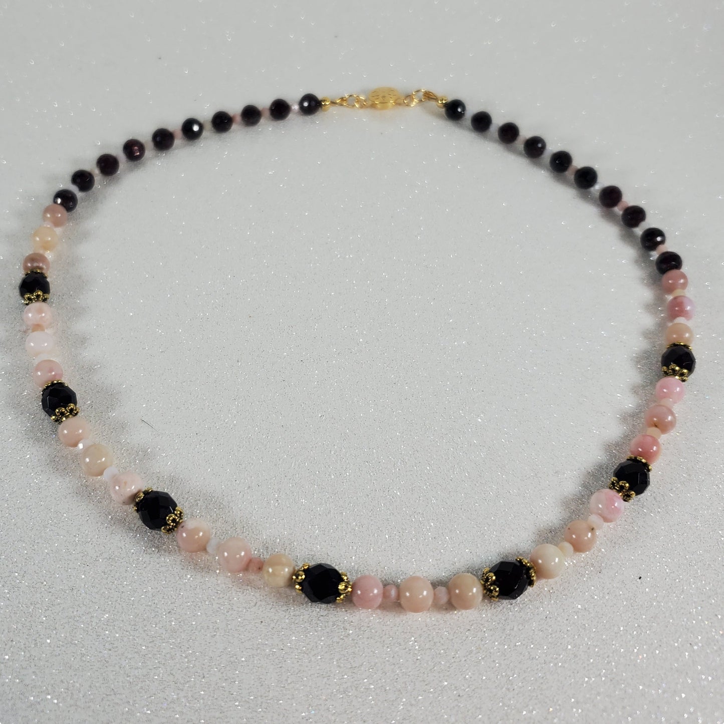 Necklace with multicolored beads on a light gray background