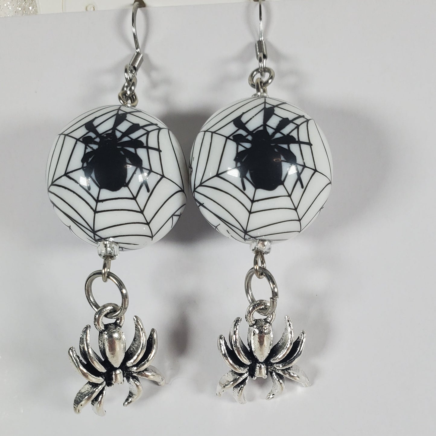 Spider earrings with spider webs on a white background
