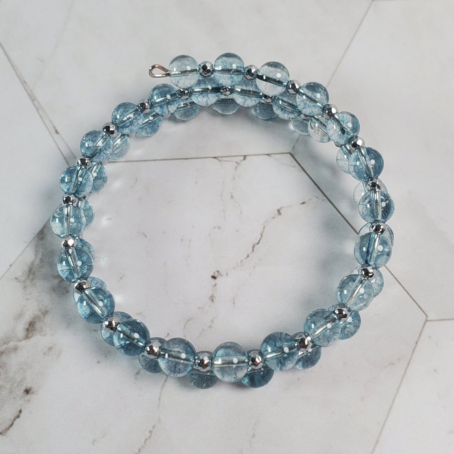 Blue beaded bracelet on a marble surface