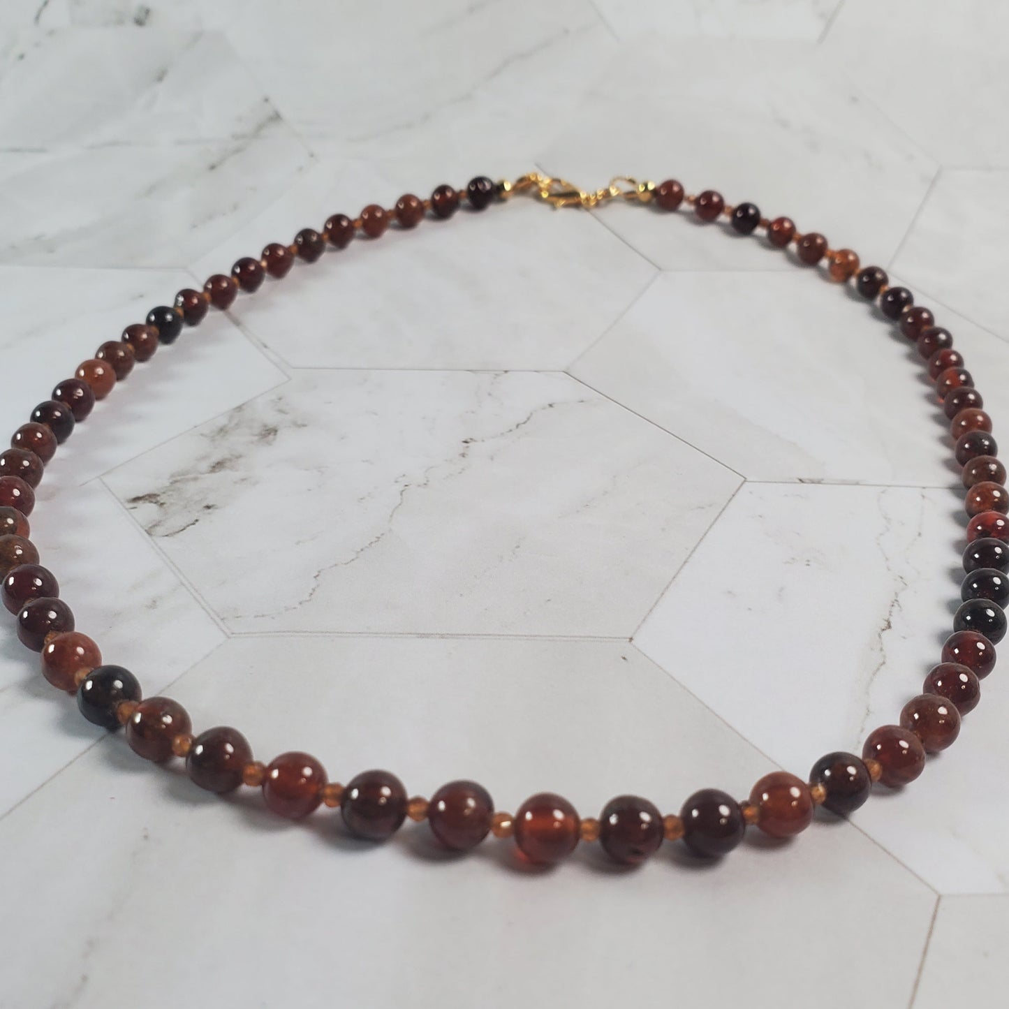 Beaded necklace on a marble surface