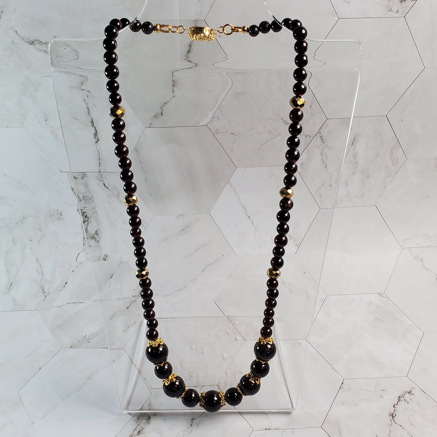 Garnet beaded necklace on a marble surface