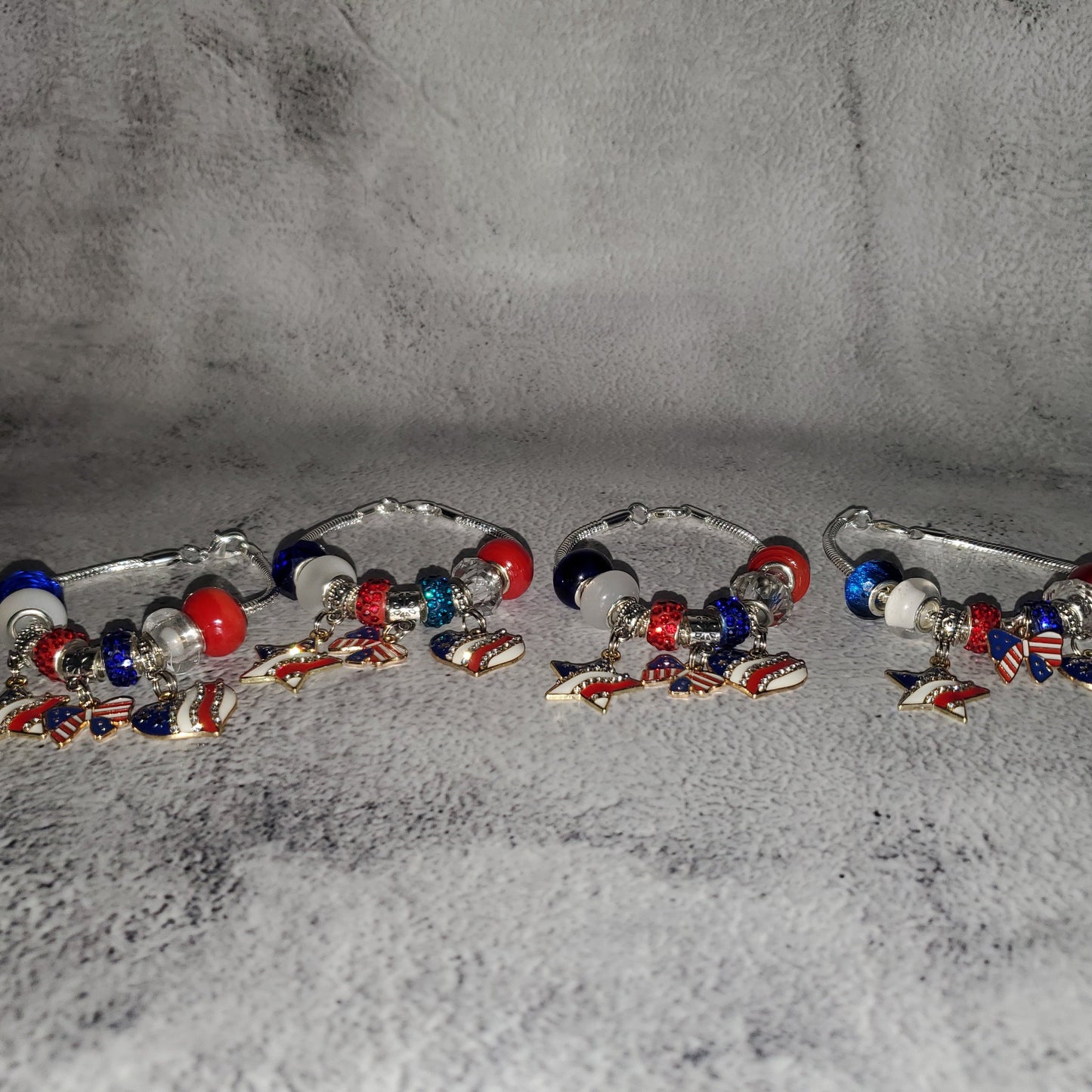 Silver 4th of July charm bracelet with red white blue beads and rhinestone American flag charms