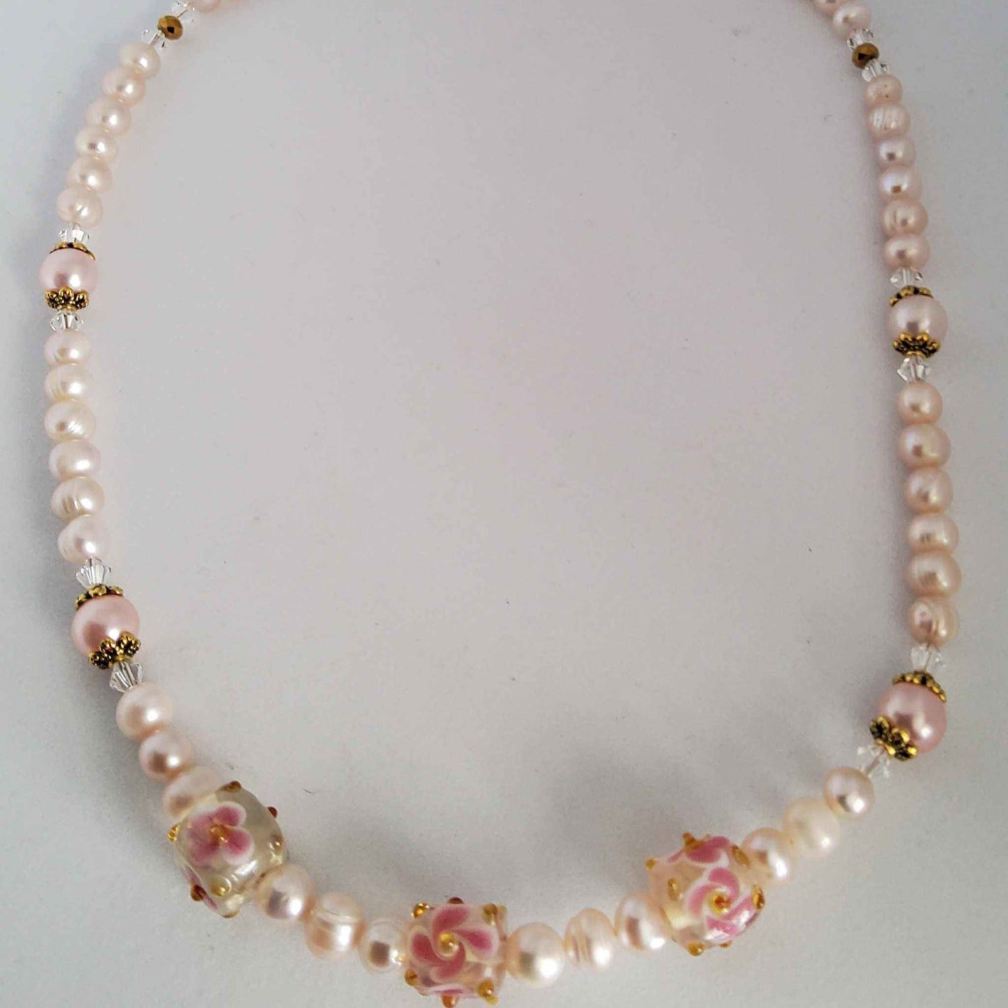 Classic Pearl Necklace with pink freshwater pearls, floral lampwork beads, Swarovski crystals, and warm brass accents