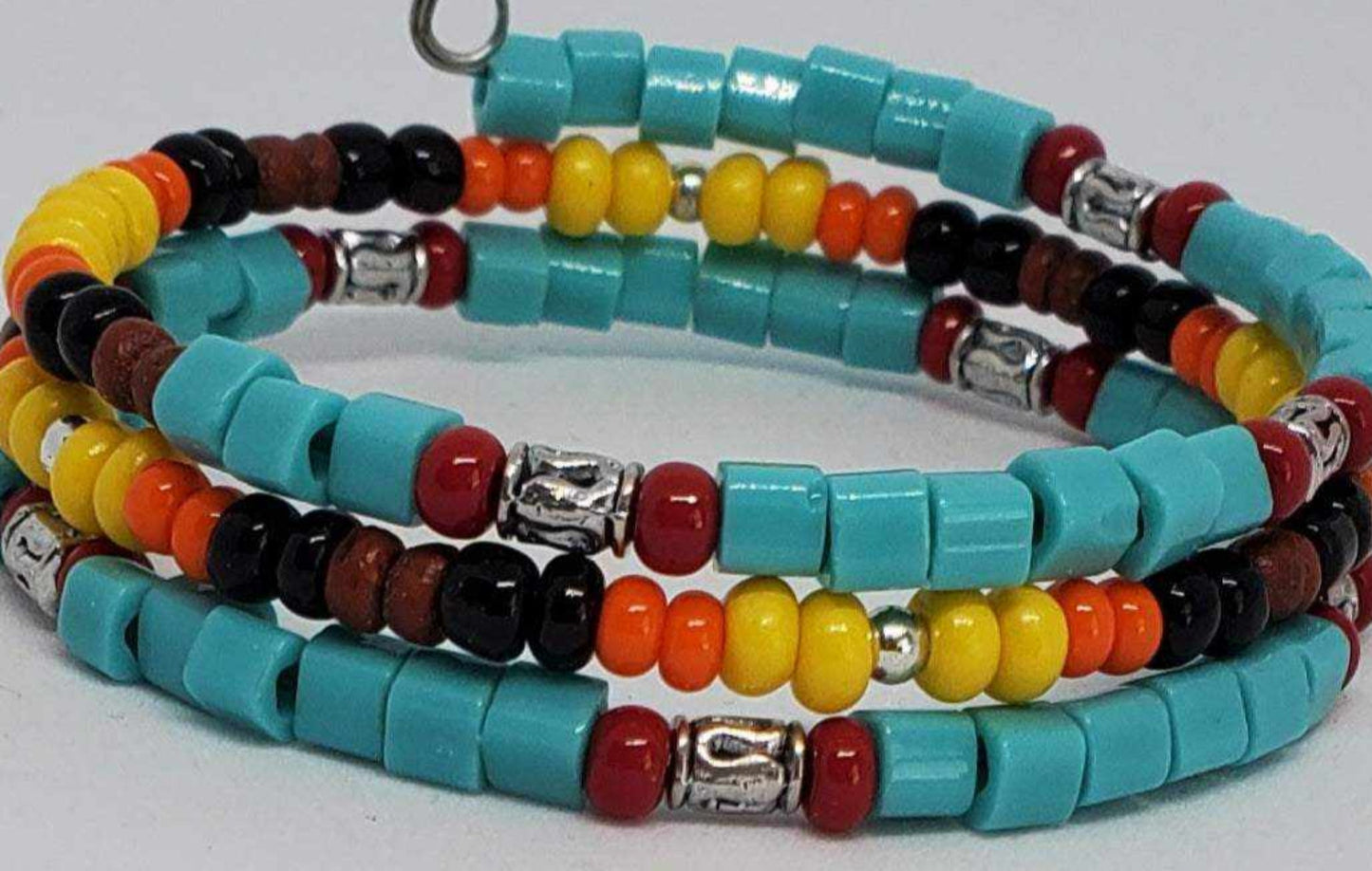 Southwestern style cuff bracelet with turquoise, yellow, orange, red beads, wood, and pewter accents
