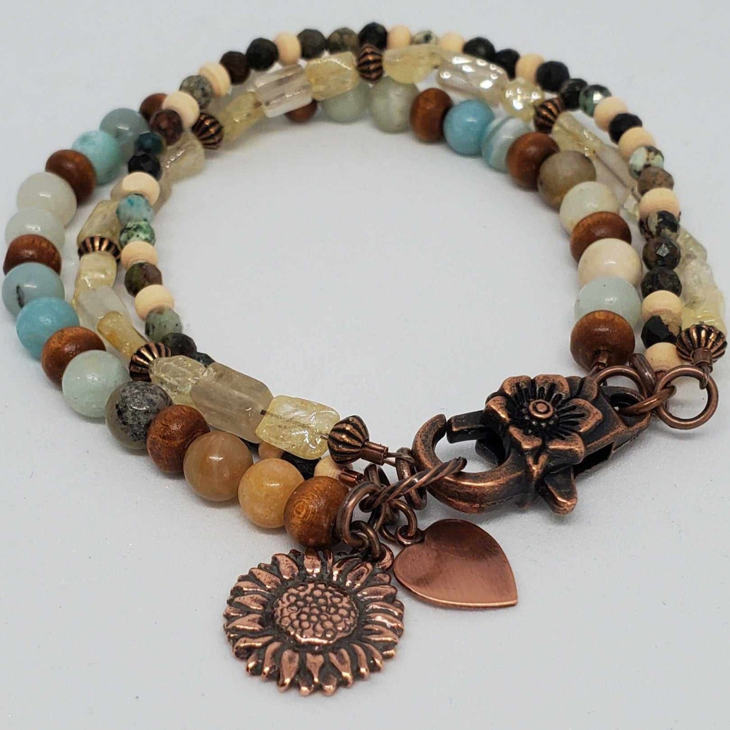 Boho triple strand charm bracelet with sunflower and heart copper charms, featuring citrine, turquoise, amazonite, and wood beads