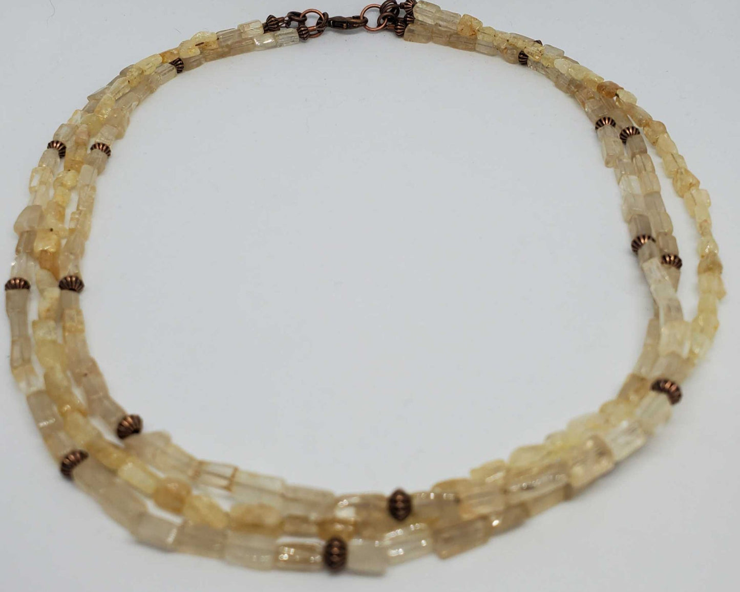 Triple strand gemstone necklace with citrine stones and copper accents