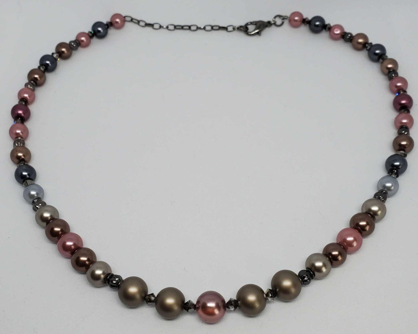 Classic Pearl Necklace with metallic pearls, gunmetal spacers, Swarovski crystals, and adjustable lobster clasp.