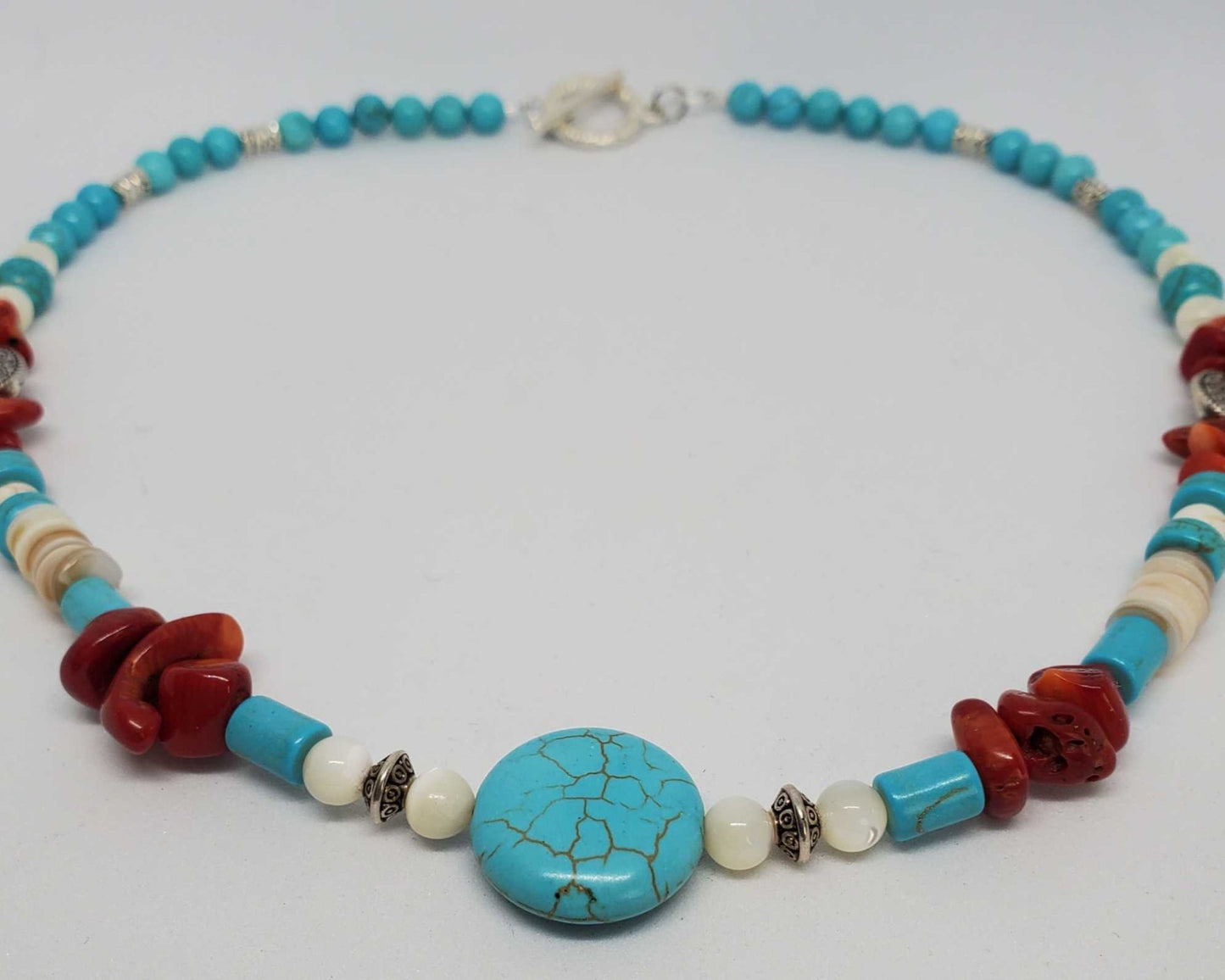 Southwestern-inspired 18-inch gemstone necklace with turquoise, coral chips, mother of pearl, and silver-tone pewter spacers