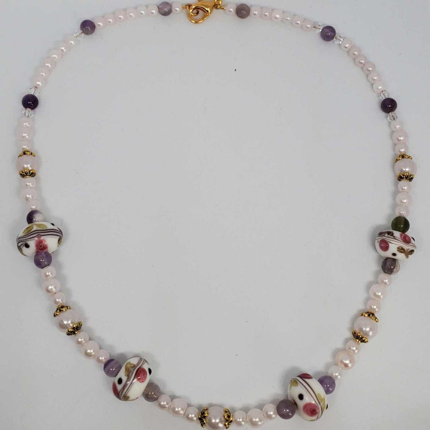 Classic Pearl Necklace with lavender acrylic pearls, amethyst stones, floral lampwork beads, and brass accents
