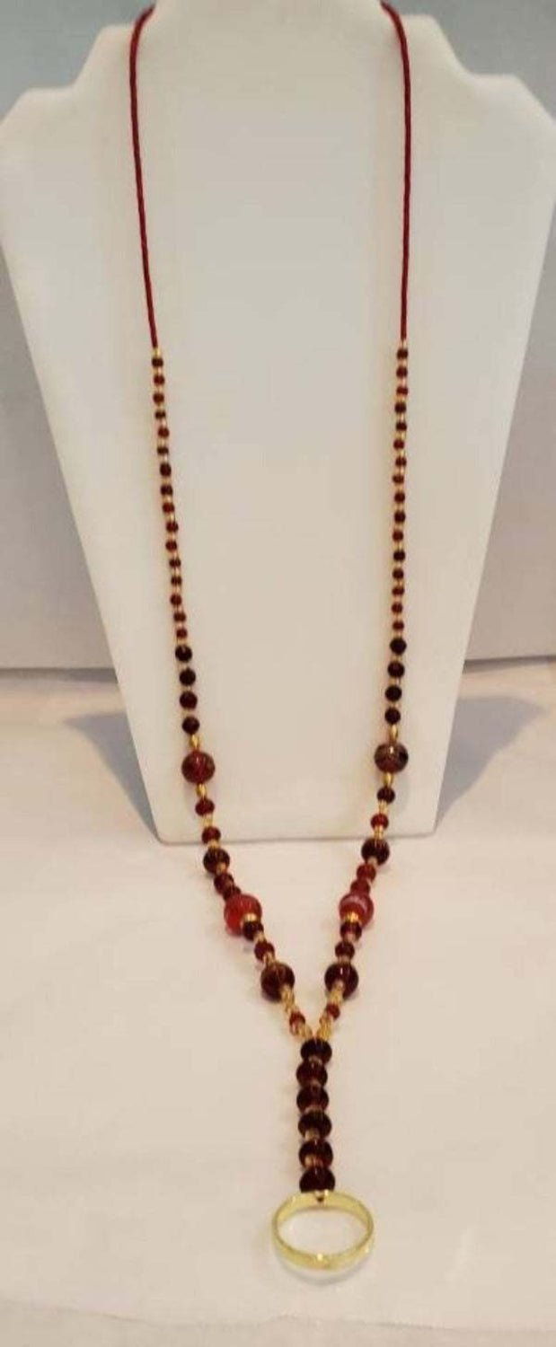Red and Gold Beaded Lanyard with brass ring on display bust
