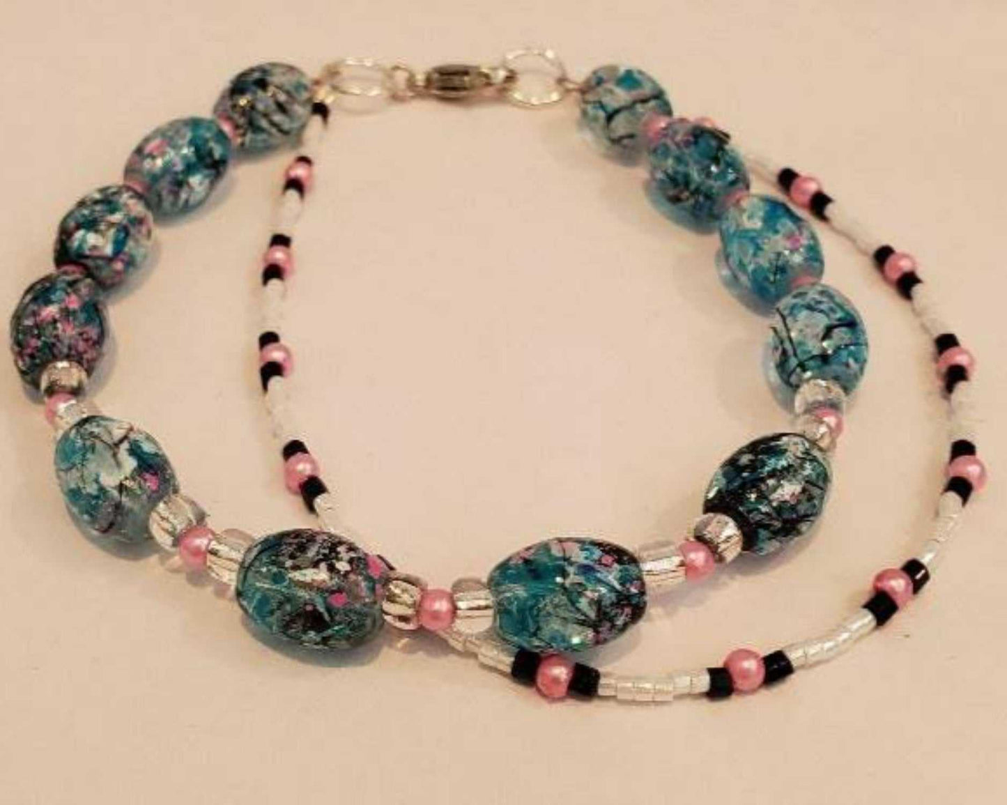 Turquoise and pink double-strand confetti bracelet with colorful beads and pearls