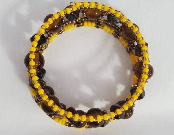 Boho brown and yellow cuff bracelet with glass, Czech, and clay beads on memory wire.