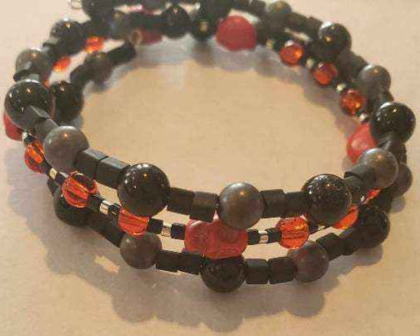 Red skull bracelet with Howlite skulls, ruby, ebony, and Czech glass beads on flexible memory wire