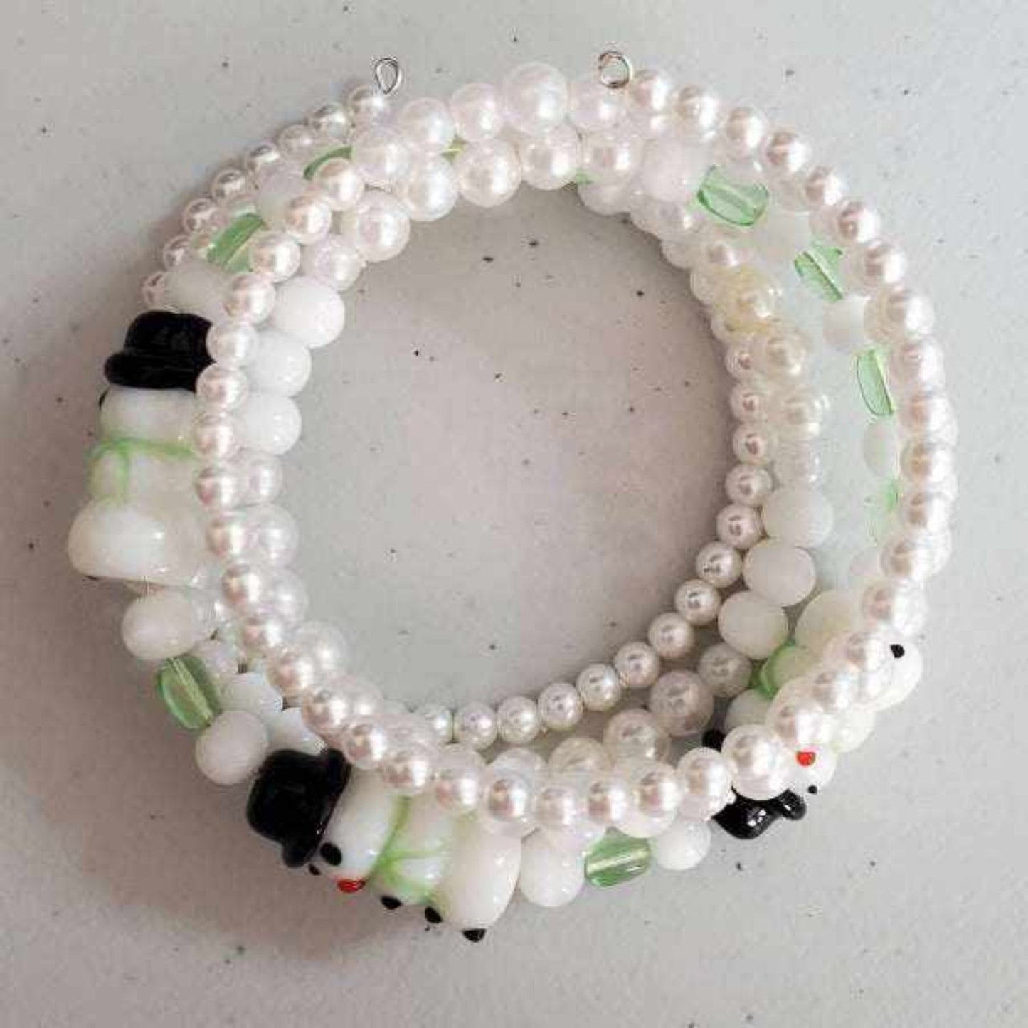 Snowman Pearl Cuff bracelet with lampwork glass beads, acrylic pearls, and green glass accents on flexible memory wire