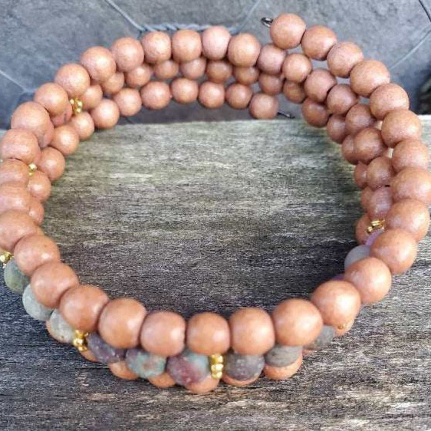 Chakra Wood Cuff gemstone bracelet with rustic beads on wooden surface for balance and natural energy