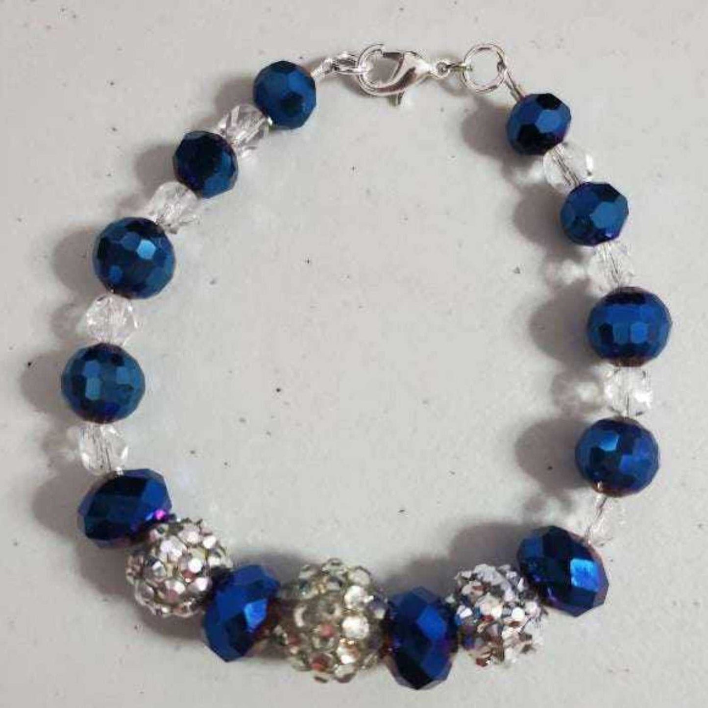 Vintage style blue brilliance bracelet with metallic blue glass beads, rhinestones, and silver-toned clasp