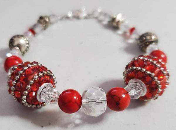 Red rhinestone bracelet with Howlite, glass crystal, acrylic, resin, and pewter beads, lobster claw clasp, 7.5 inches.