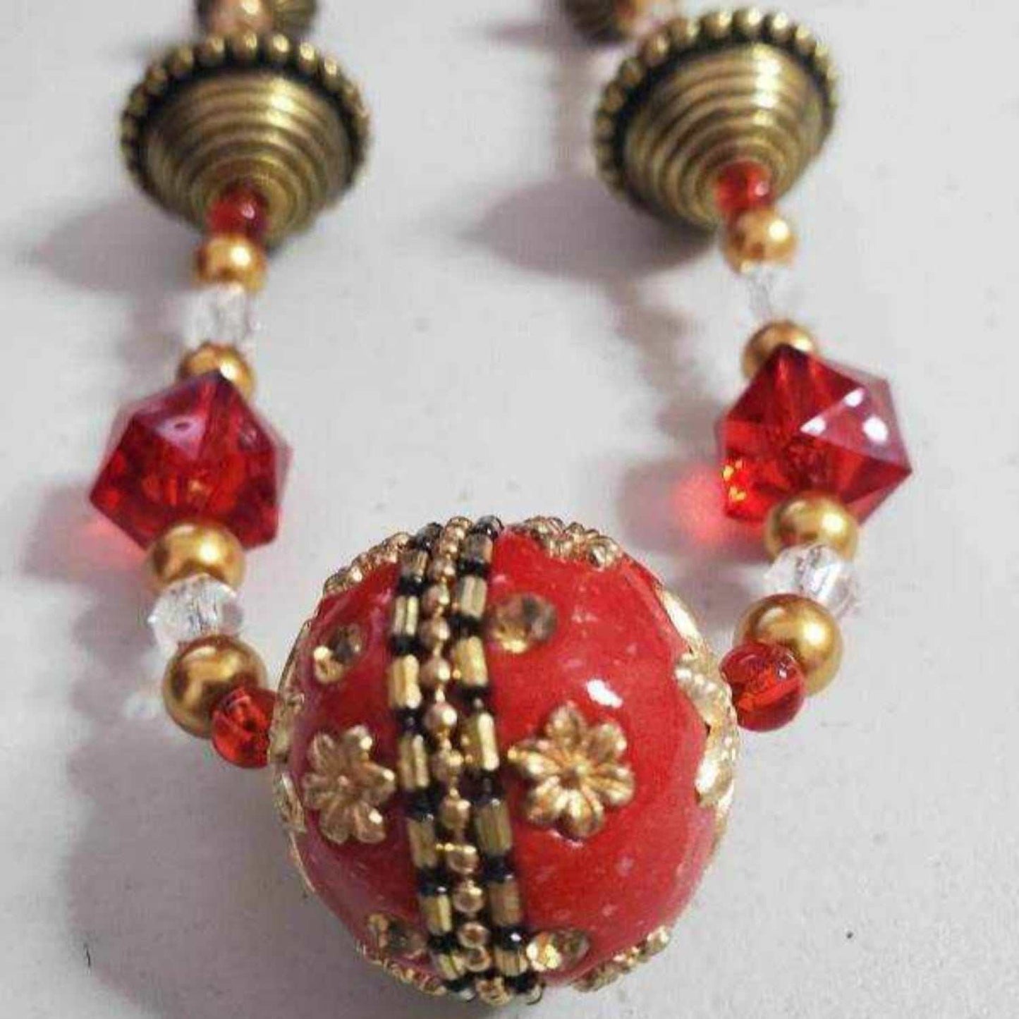 Vintage style Eastern Spirit necklace with red and gold beads and intricate floral details