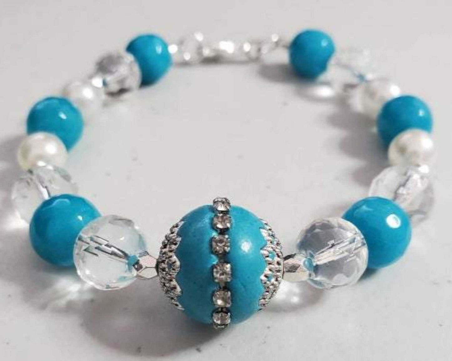 Vintage fashion turquoise bracelet with crystal and glass beads on white background