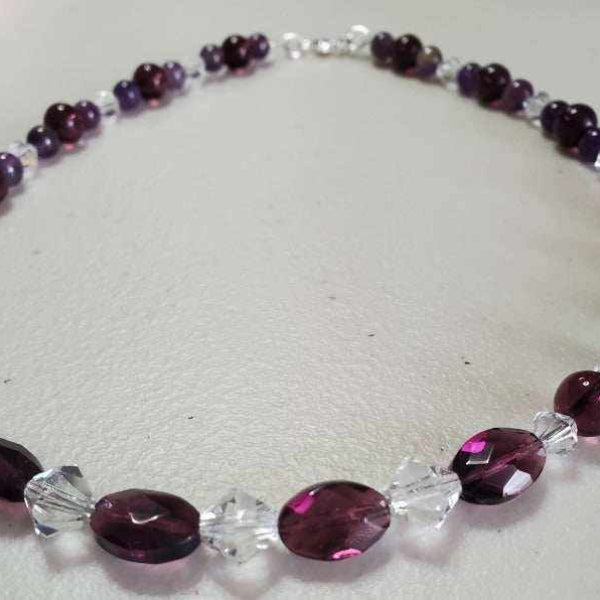 Handcrafted gemstone necklace with faceted amethyst beads, genuine amethyst, and sparkling Austrian crystals on a 16-inch strand with lobster clasp