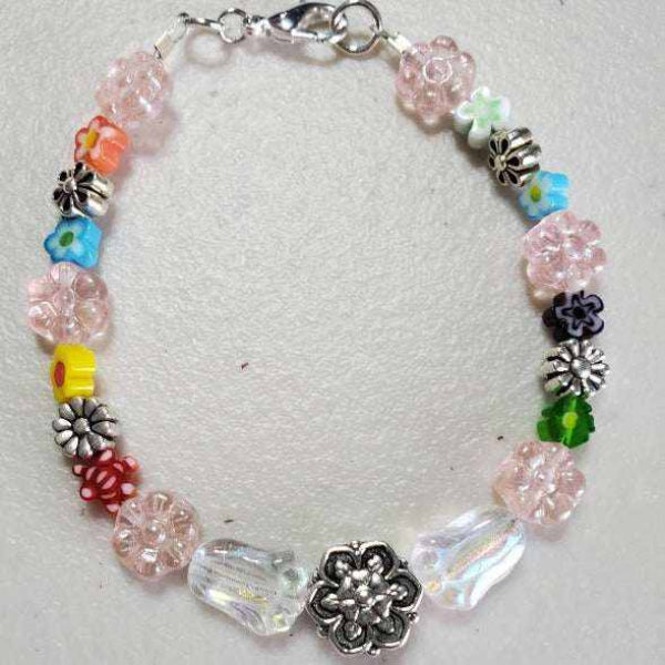 Handcrafted floral bracelet with colorful Millefiori beads, pewter daisy accents, and lobster claw clasp