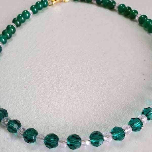 Emerald choker necklace with green glass beads and rose Austrian crystal accents on a 14-inch chain with lobster clasp
