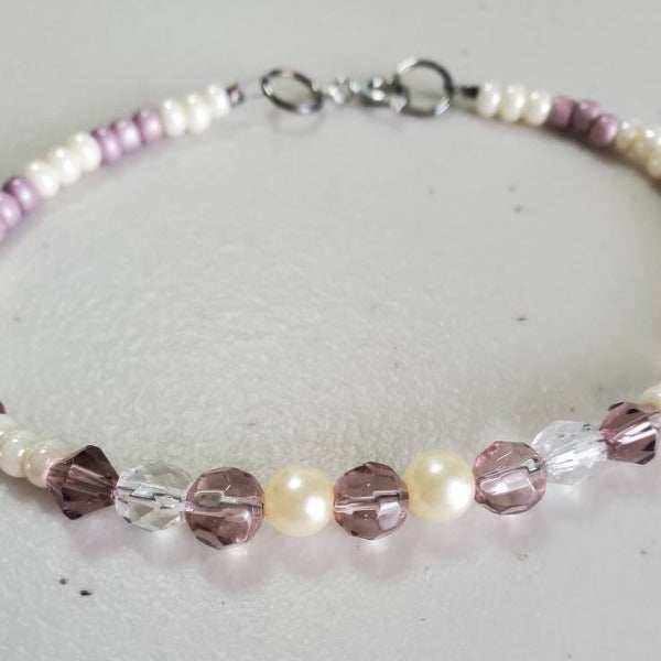 Handcrafted pearl bracelet with lavender Czech glass pearls and amethyst Austrian crystals on an 8-inch silver clasp strand