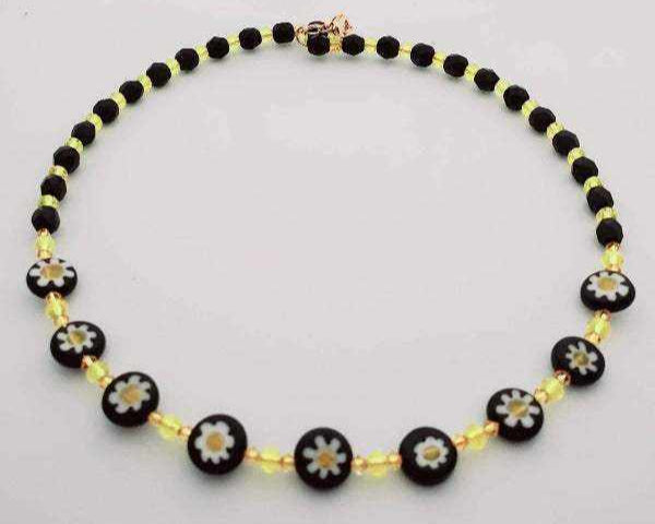 Black and white floral necklace with daisy beads and yellow crystal accents