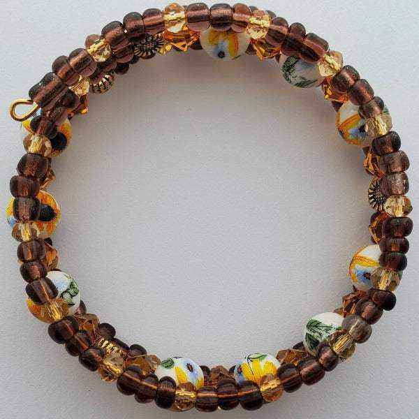 Sunflower Boho cuff bracelet with hand-painted glass beads, Austrian and Swarovski crystals, and brown Czech glass accents on memory wire base