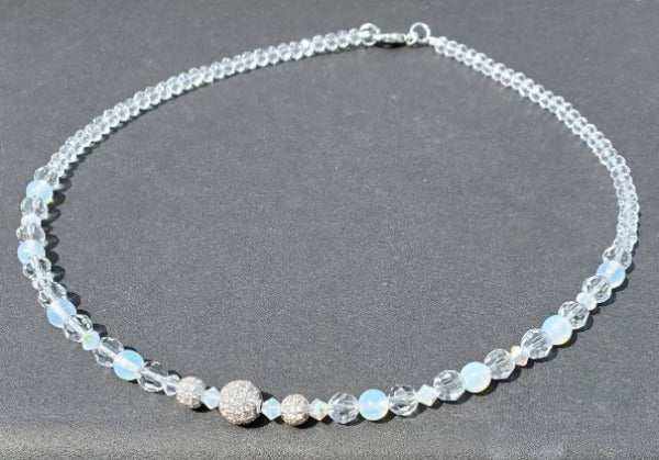 Crystal Choker Pavé Necklace with pavé crystals, opal, and glass beads on a black background