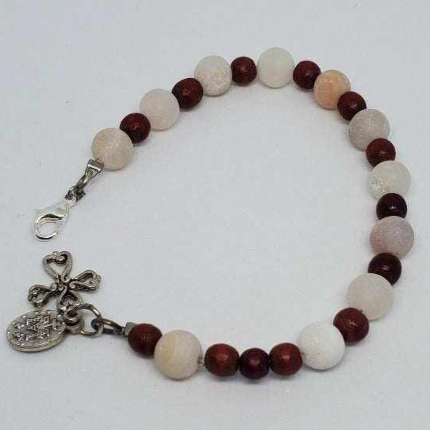 Handcrafted prayer bracelet with semiprecious stones, wooden beads, and pewter cross charm