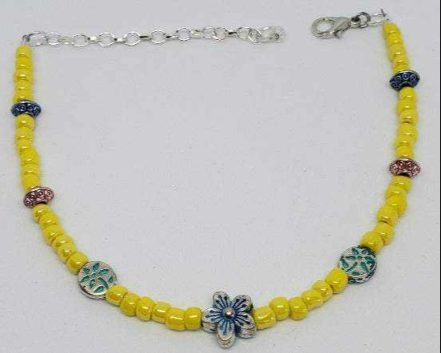 Yellow beaded anklet with floral charm and adjustable silver clasp