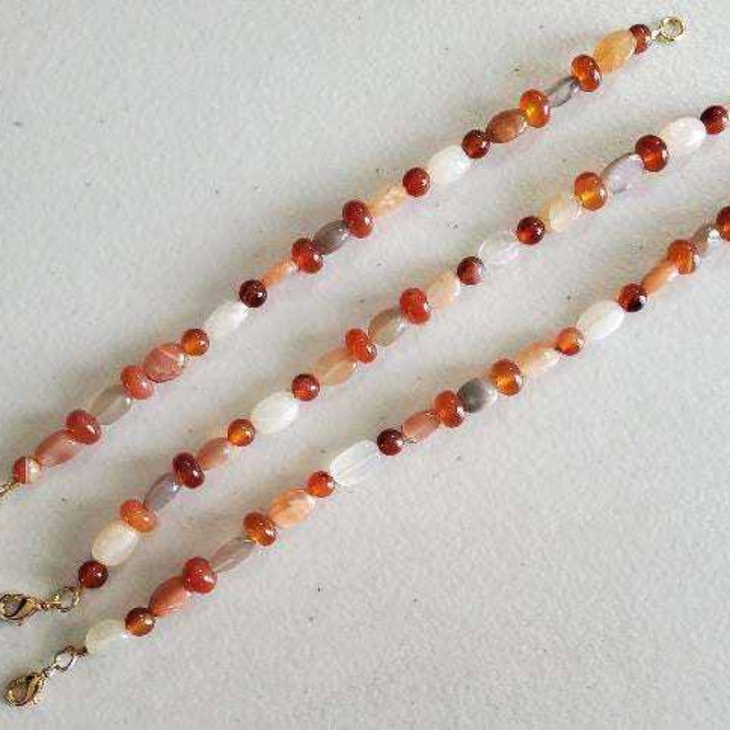 Carnelian and Moonstone gemstone bracelet with brass accents and lobster claw clasp.
