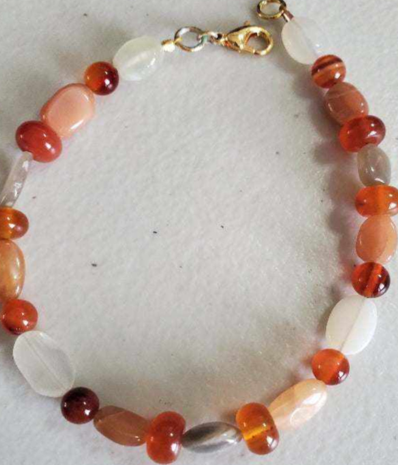 Carnelian and Moonstone gemstone bracelet with brass accents and lobster claw clasp.