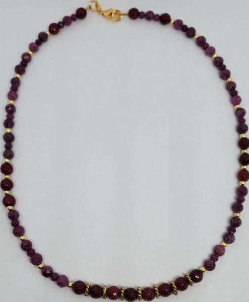 Ruby choker necklace with genuine ruby beads and brass spacers, secured by a lobster clasp.