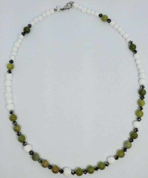 Gemstone necklace with peridot beads, vintage Japanese glass, and Swarovski crystals on white background