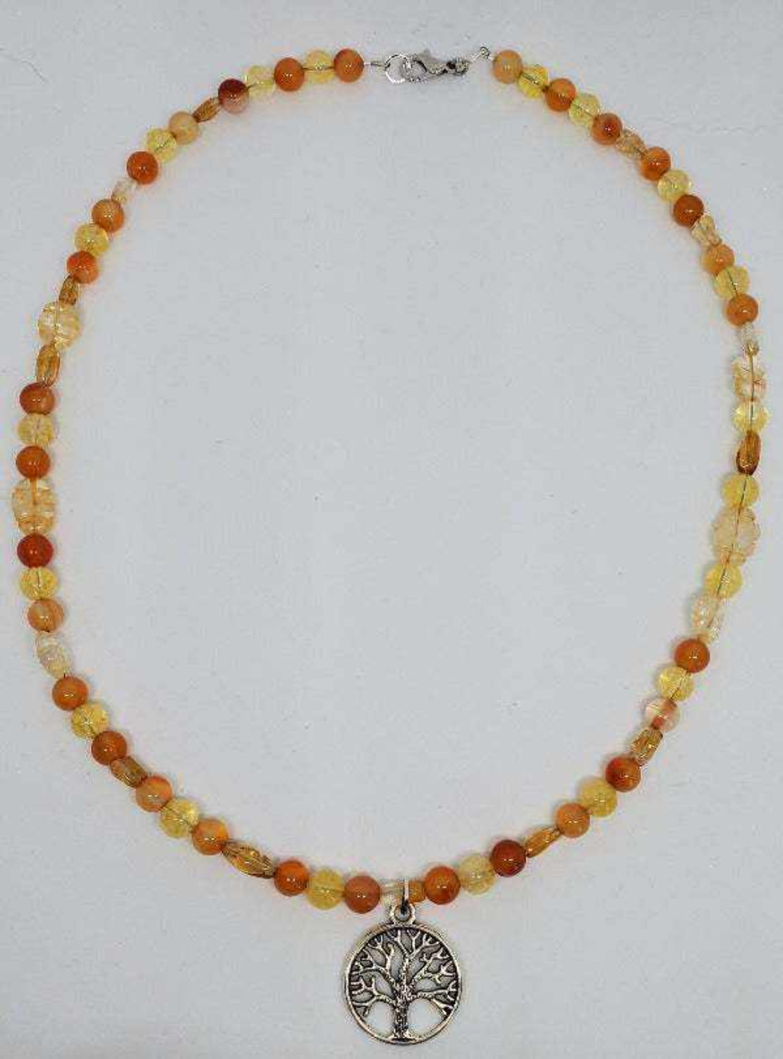 Gemstone necklace with Tree of Life pewter pendant featuring orange and yellow beads and lobster clasp