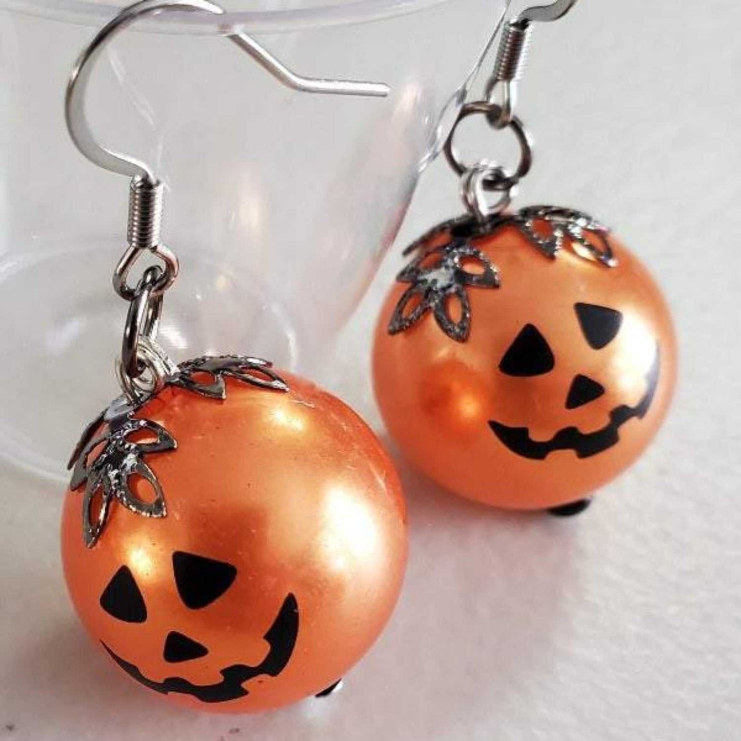 Jack O' Lantern drop earrings with orange acrylic beads and black filigree caps for Halloween