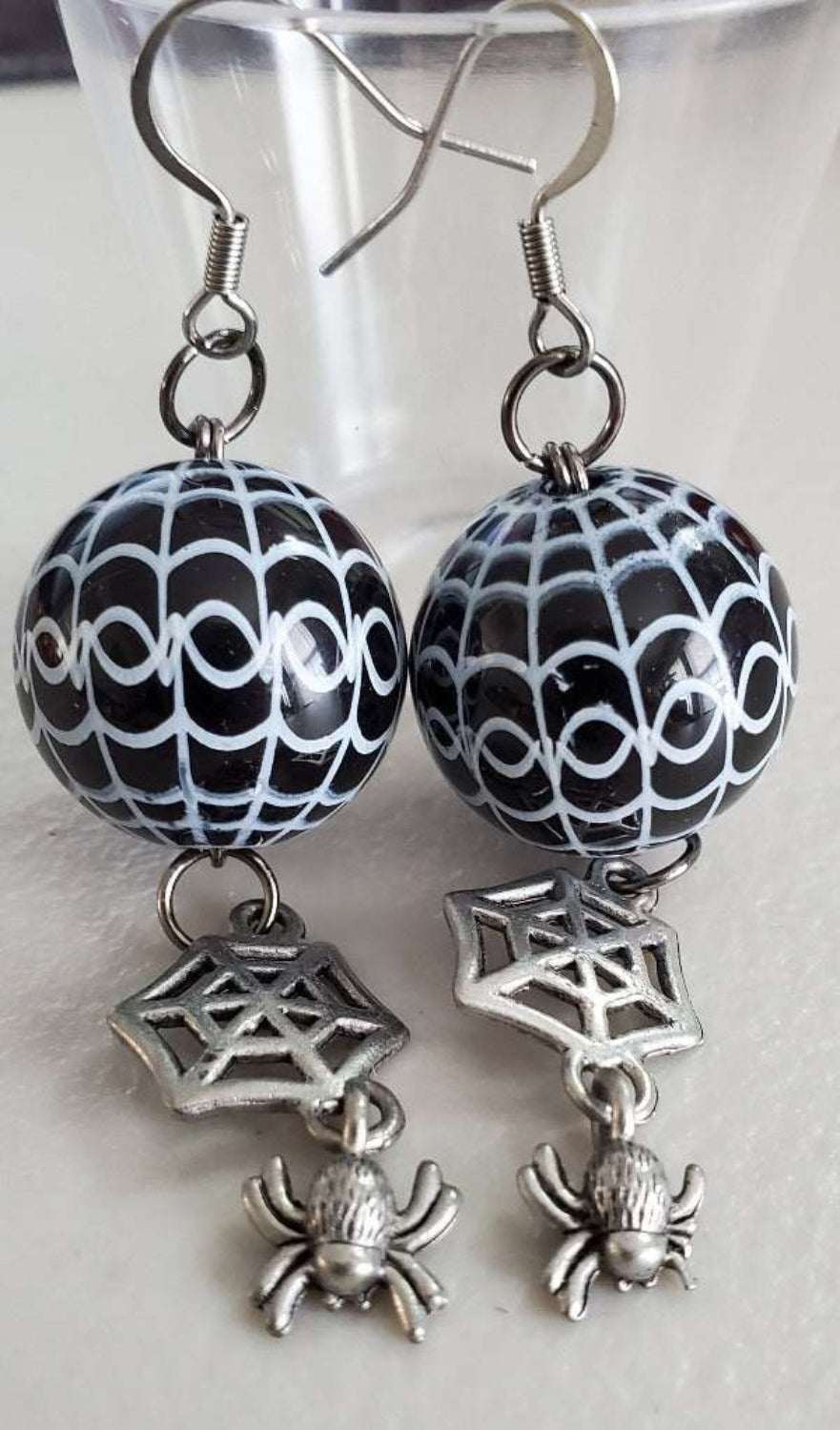 Black spiderweb drop earrings with acrylic beads and pewter spider charms