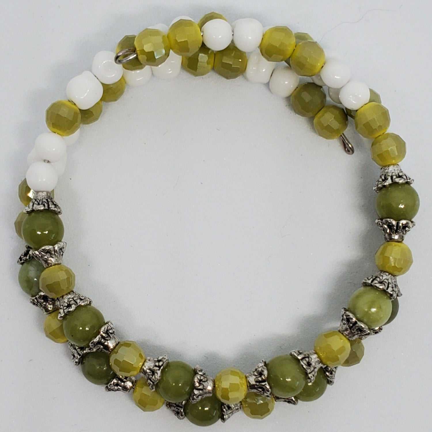 Handcrafted gemstone bracelet with genuine Peridot, vintage Japanese glass beads, and silver-plated accents on memory wire cuff