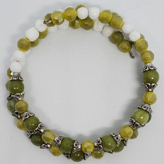 Handcrafted gemstone bracelet with genuine Peridot, vintage Japanese glass beads, and silver-plated accents on memory wire cuff